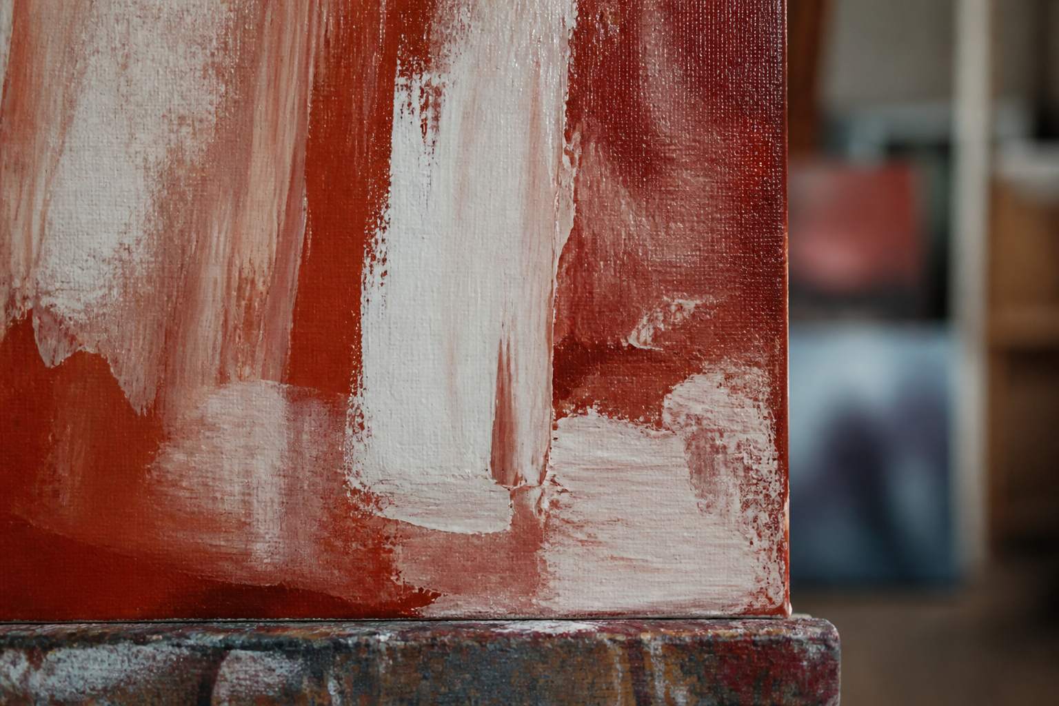 Close view of a wet painted canvas resting in the studio